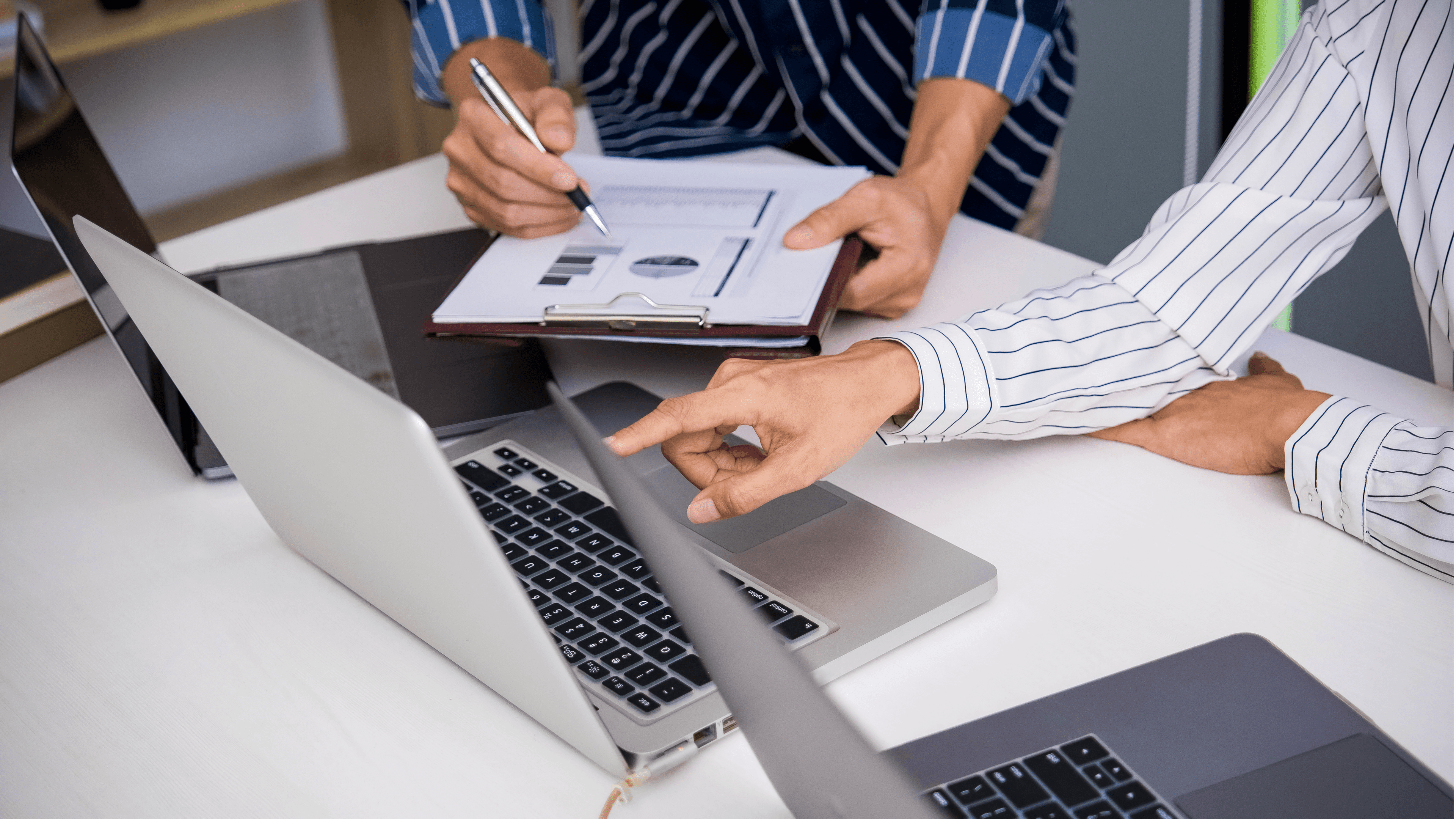Person working on laptop with documents